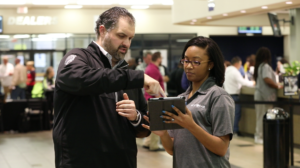 Dealer and Nextgear rep looking at a tablet