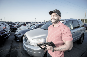 Dealer on Car Lot Using iPad to Manage Floor Plan Line of Credit