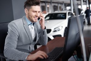 Dealer on using the computer and talking on the phone