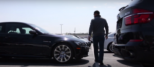 Dealer walking between cars