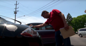 Dealer looking closely at a car