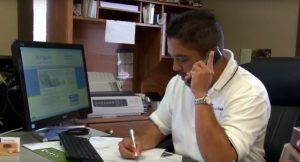 Dealer on the phone at his desk