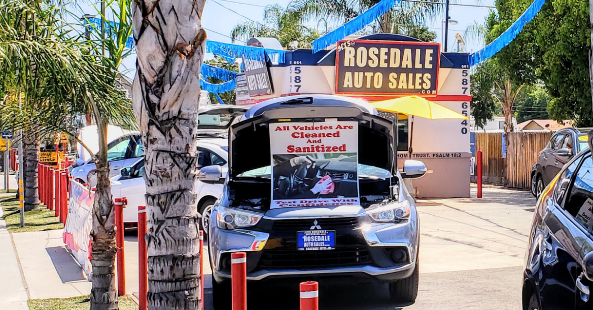 A car with a sign that says it has been sanitized