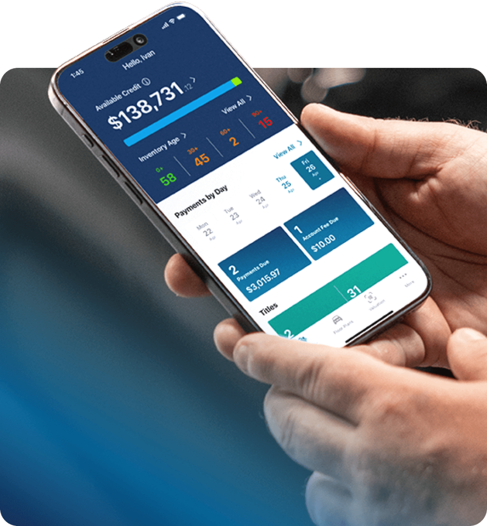 Man holding mobile phone with the NextGear App open.